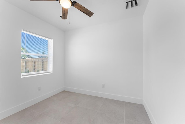 empty room featuring ceiling fan and light tile patterned floors