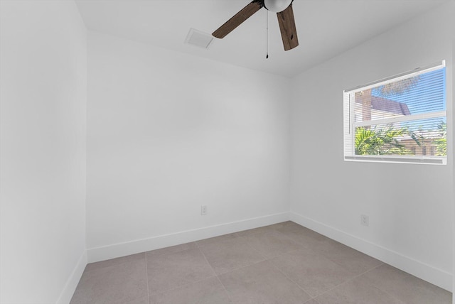 empty room with light tile patterned floors and ceiling fan