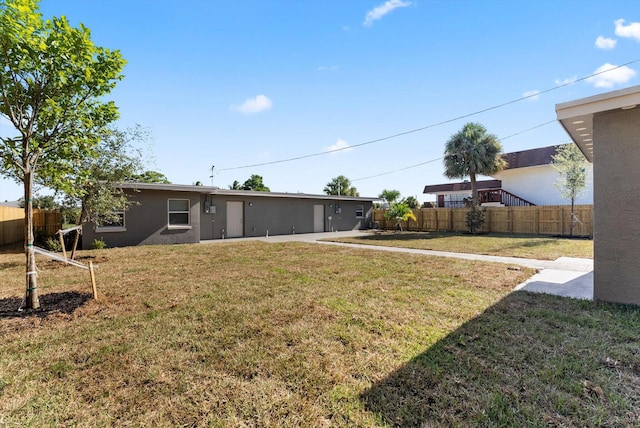 rear view of property featuring a yard