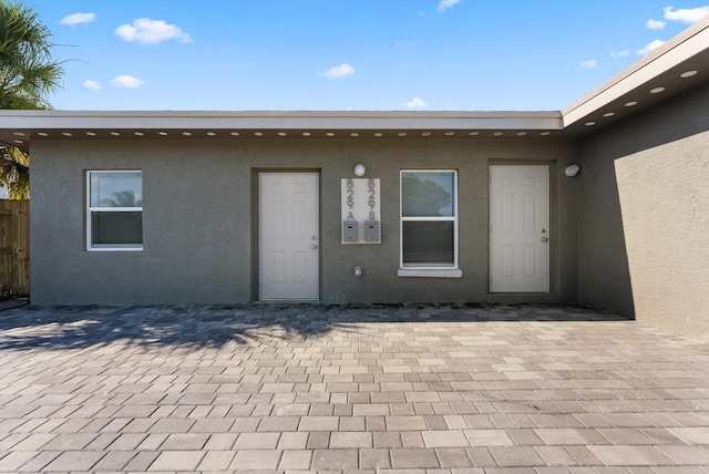 doorway to property featuring a patio