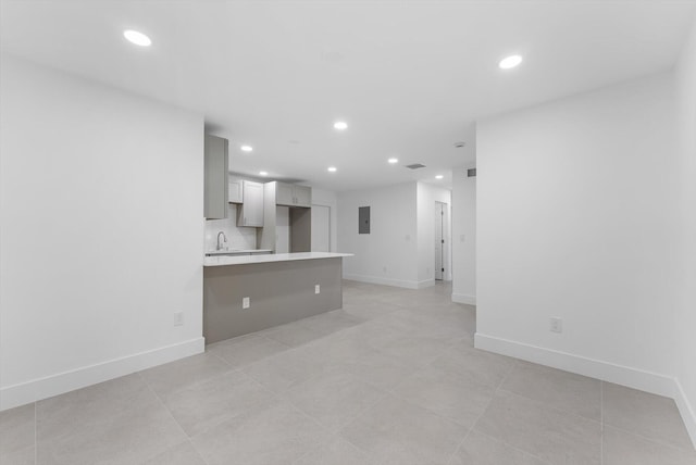 unfurnished living room with sink and electric panel