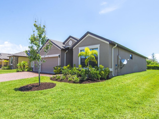 view of front facade with a front yard and a garage