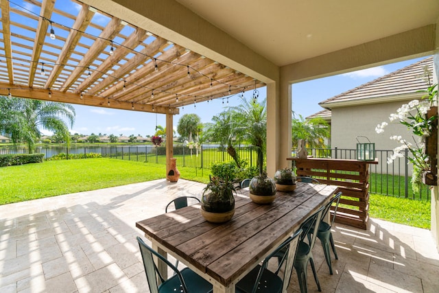 view of patio featuring outdoor dining area, a pergola, fence, and a water view