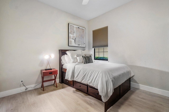 bedroom with ceiling fan, baseboards, and wood finished floors