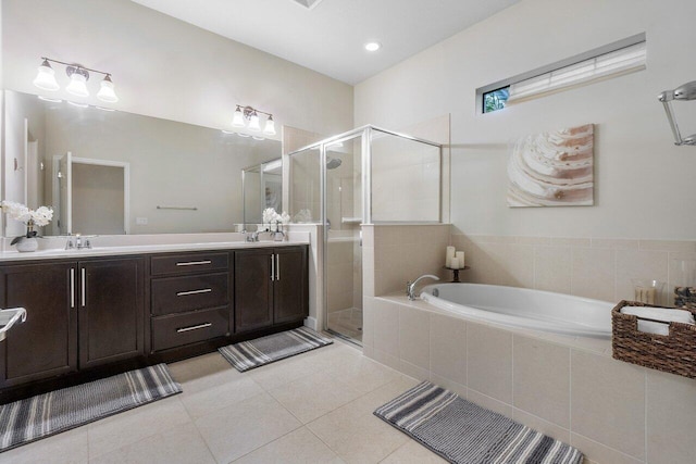 full bathroom featuring double vanity, a bath, a shower stall, and tile patterned flooring