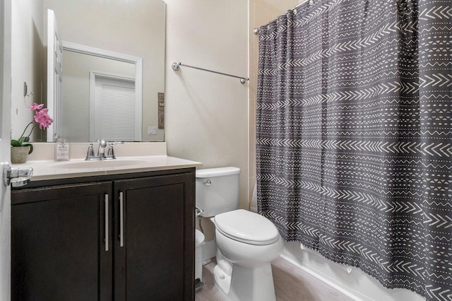 bathroom featuring curtained shower, toilet, wood finished floors, and vanity