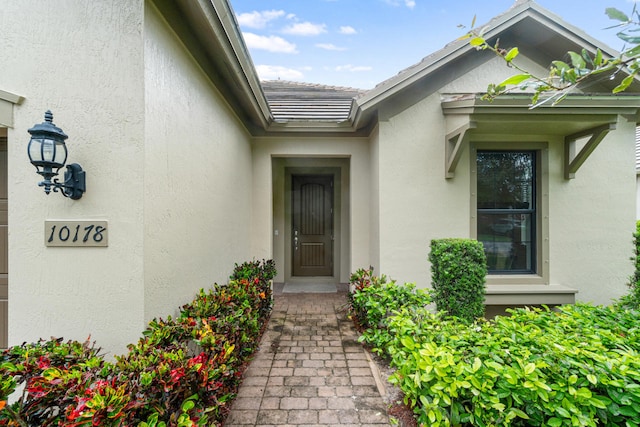 entrance to property with stucco siding