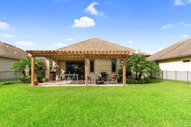 rear view of house featuring a patio, a lawn, a pergola, and a fenced backyard