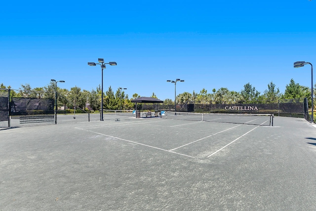 view of tennis court featuring fence