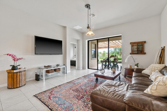 living area with light tile patterned floors, baseboards, and visible vents