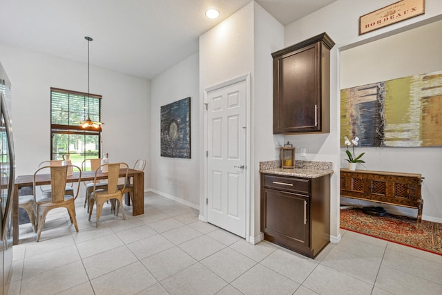 dining space with light tile patterned floors, baseboards, and recessed lighting