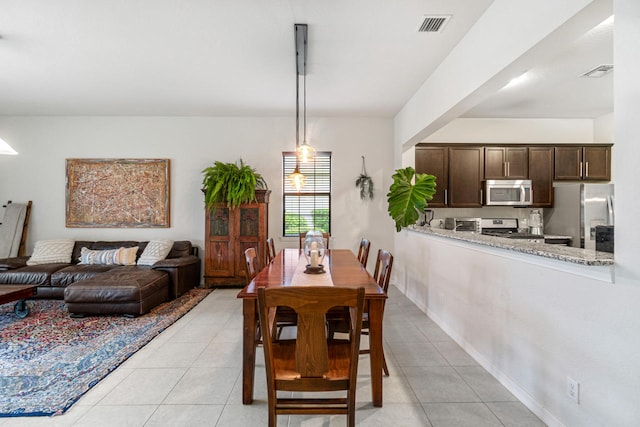 dining room with light tile patterned floors and visible vents