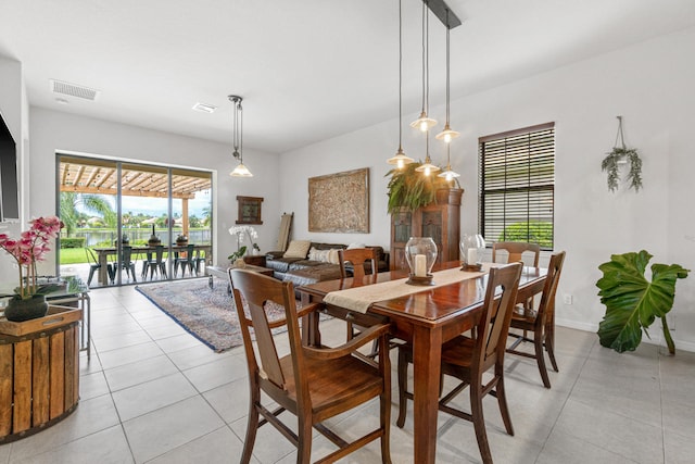 dining space featuring light tile patterned floors, baseboards, and visible vents