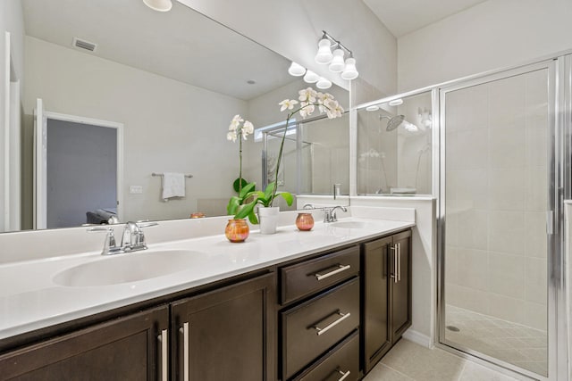 bathroom with a sink, visible vents, a stall shower, and double vanity