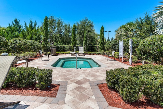 view of pool featuring a fenced backyard, a hot tub, and a patio