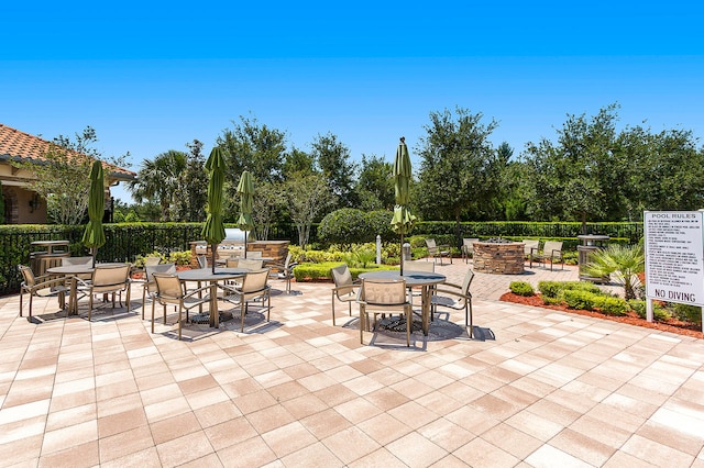 view of patio / terrace featuring an outdoor fire pit, outdoor dining area, and fence