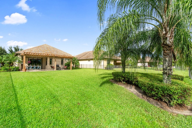 view of yard with a patio area, a pergola, and a fenced backyard