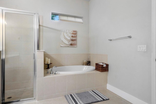 full bathroom with tile patterned flooring, a garden tub, baseboards, and a stall shower