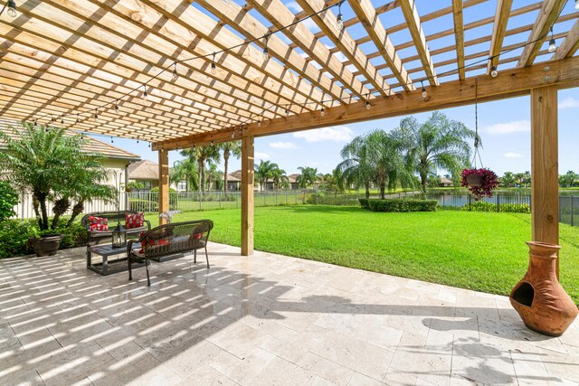 view of patio / terrace featuring a water view, a fenced backyard, and a pergola