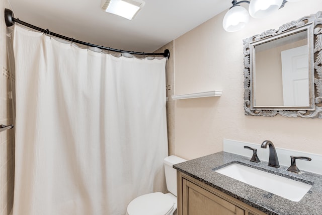 bathroom with vanity, toilet, and walk in shower