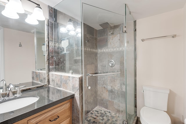 bathroom with vanity, toilet, and walk in shower