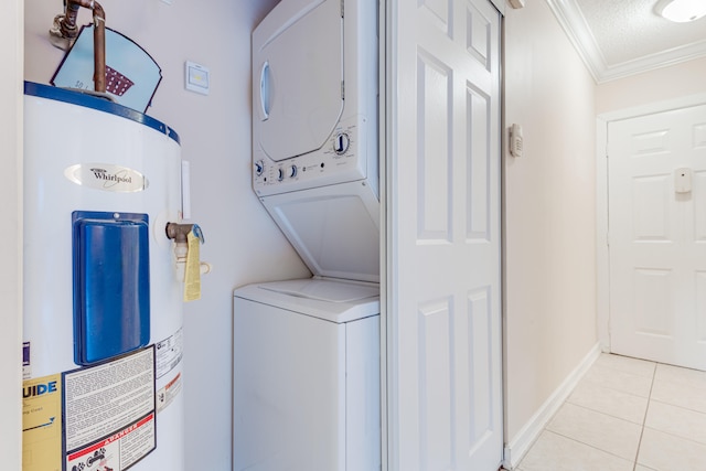 washroom with crown molding, stacked washer and dryer, light tile patterned floors, a textured ceiling, and water heater