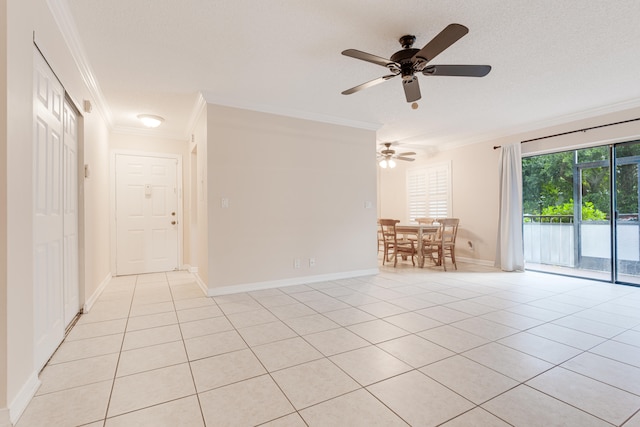 tiled spare room featuring ceiling fan, a textured ceiling, and ornamental molding