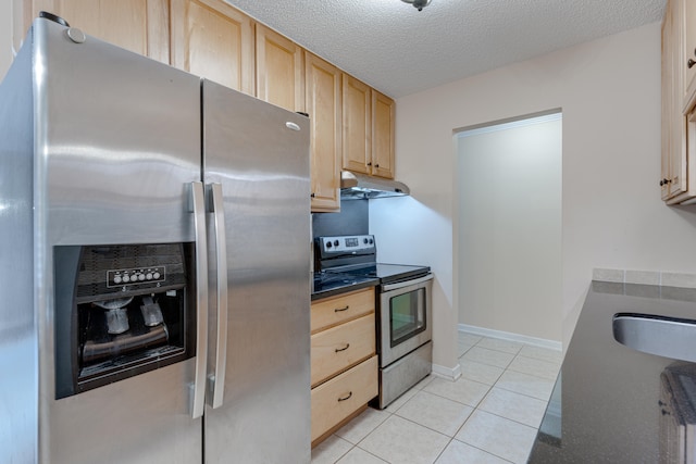 kitchen featuring sink, a textured ceiling, light brown cabinetry, light tile patterned floors, and appliances with stainless steel finishes