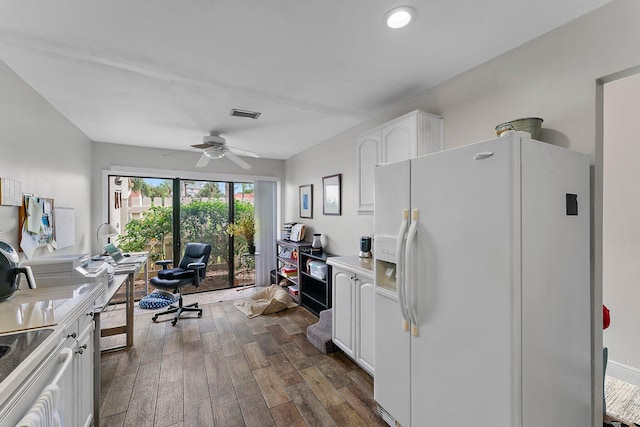 kitchen featuring white cabinetry, dark wood-type flooring, stainless steel stove, ceiling fan, and white fridge with ice dispenser