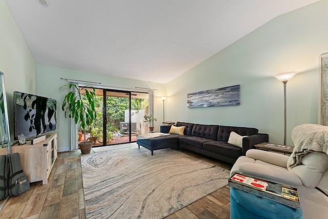 living room with wood-type flooring and vaulted ceiling