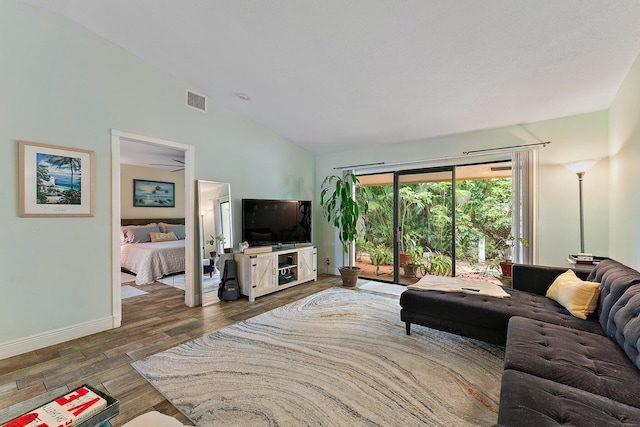 living room featuring lofted ceiling and dark wood-type flooring