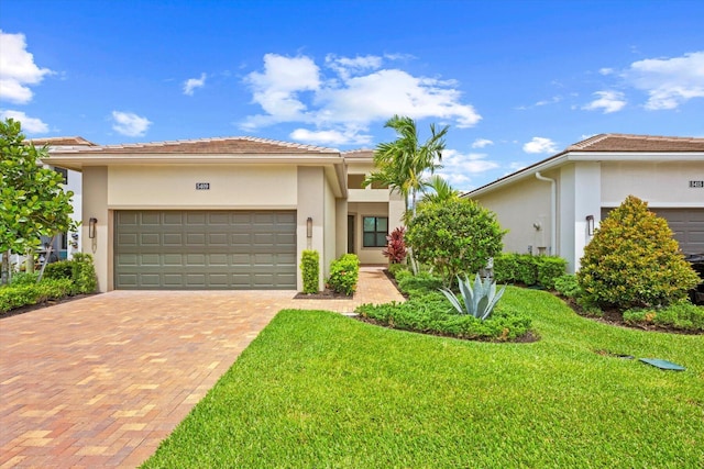 view of front of house featuring a front yard and a garage