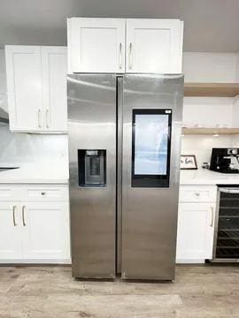 kitchen with stainless steel fridge, white cabinetry, wine cooler, and light hardwood / wood-style flooring