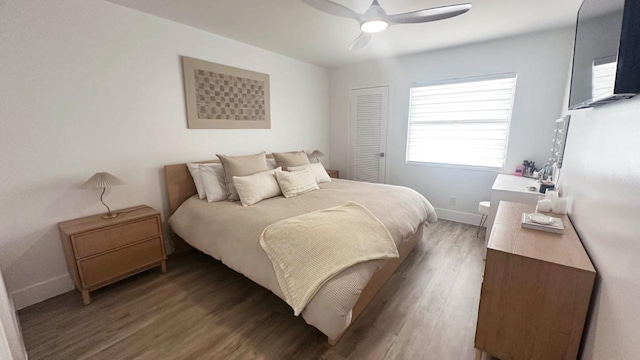 bedroom featuring dark hardwood / wood-style flooring, a closet, and ceiling fan