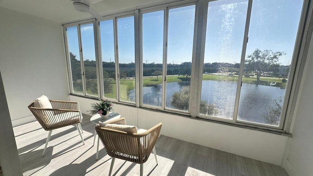 sunroom / solarium featuring a water view