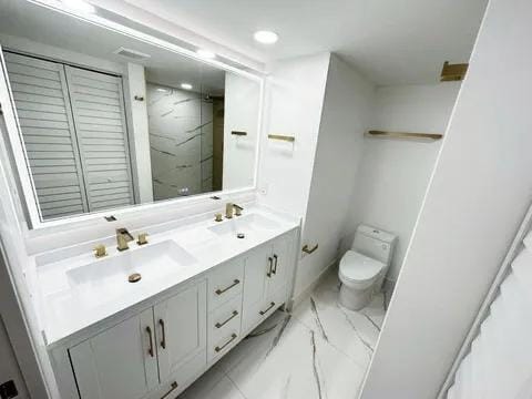 bathroom with vanity and toilet