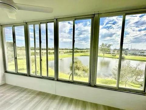 unfurnished sunroom featuring a water view and a wealth of natural light