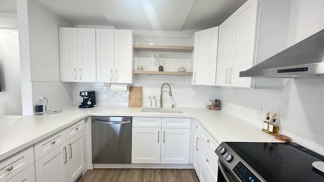 kitchen with white cabinets, stainless steel appliances, wall chimney exhaust hood, and sink