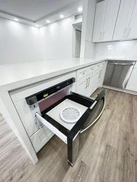 interior details with white cabinetry and light hardwood / wood-style floors