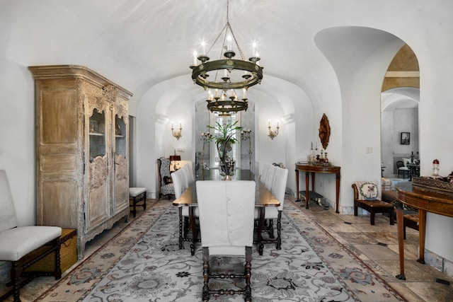 tiled dining room featuring a notable chandelier