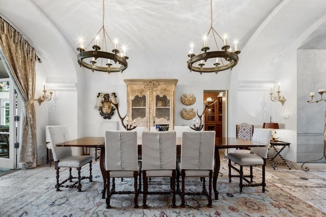 dining space featuring vaulted ceiling and a chandelier