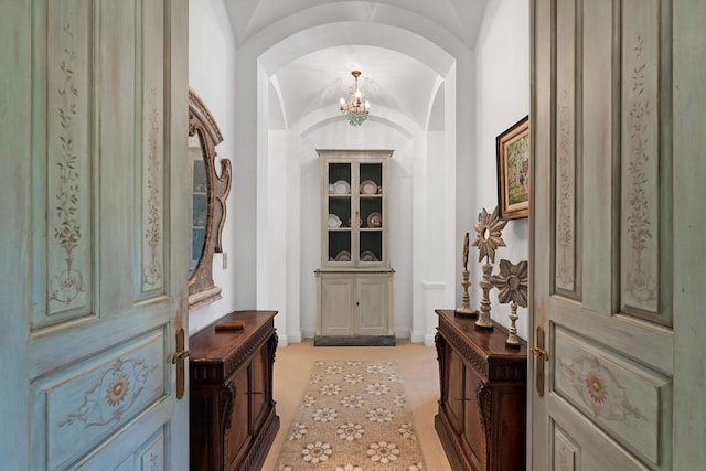 entryway featuring light colored carpet and arched walkways