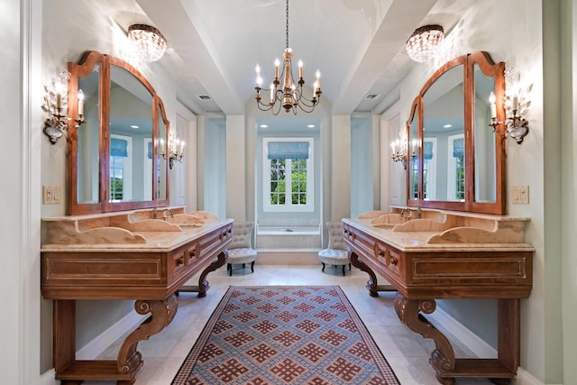 bathroom featuring a chandelier, tile patterned flooring, a garden tub, and a sink