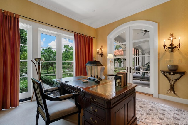 office space with baseboards, arched walkways, ornamental molding, french doors, and light carpet