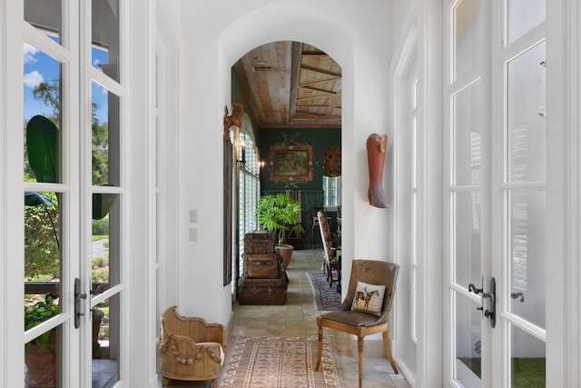 sunroom / solarium featuring french doors and wood ceiling