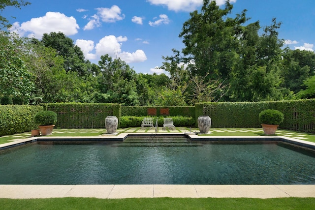 view of pool with a fenced in pool and fence