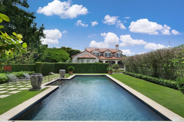 view of pool with a fenced in pool and fence