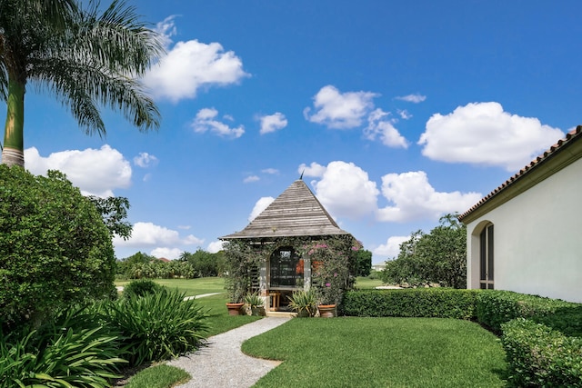 surrounding community with a gazebo and a yard