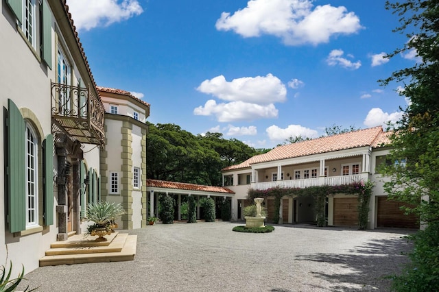 exterior space featuring stucco siding and a tile roof