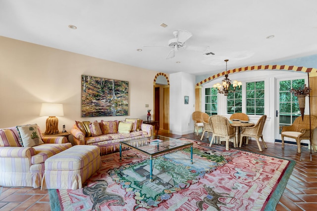 living room with tile floors and ceiling fan with notable chandelier